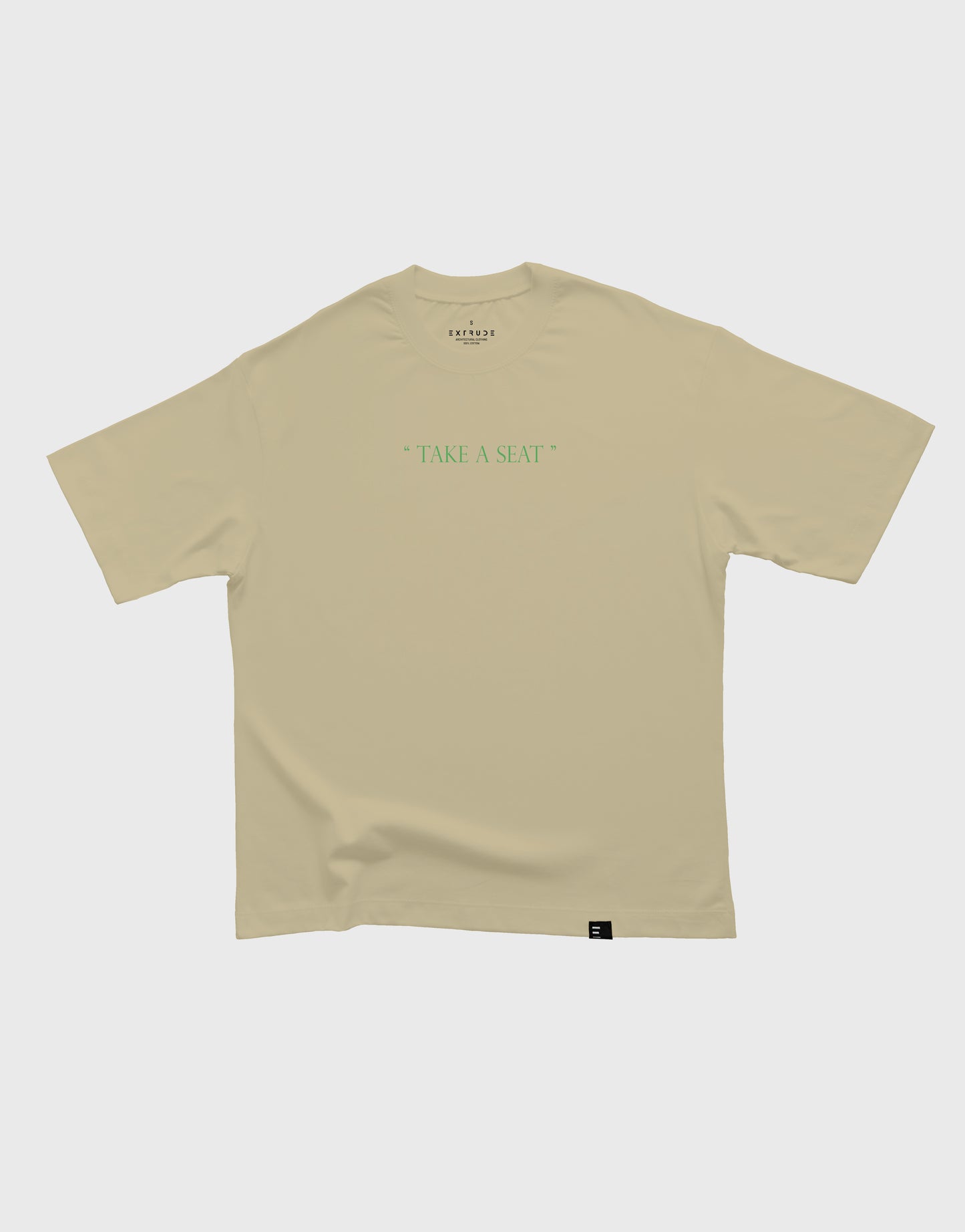 Camiseta unisex beige Extrude Take a Seat con frase en verde en el pecho